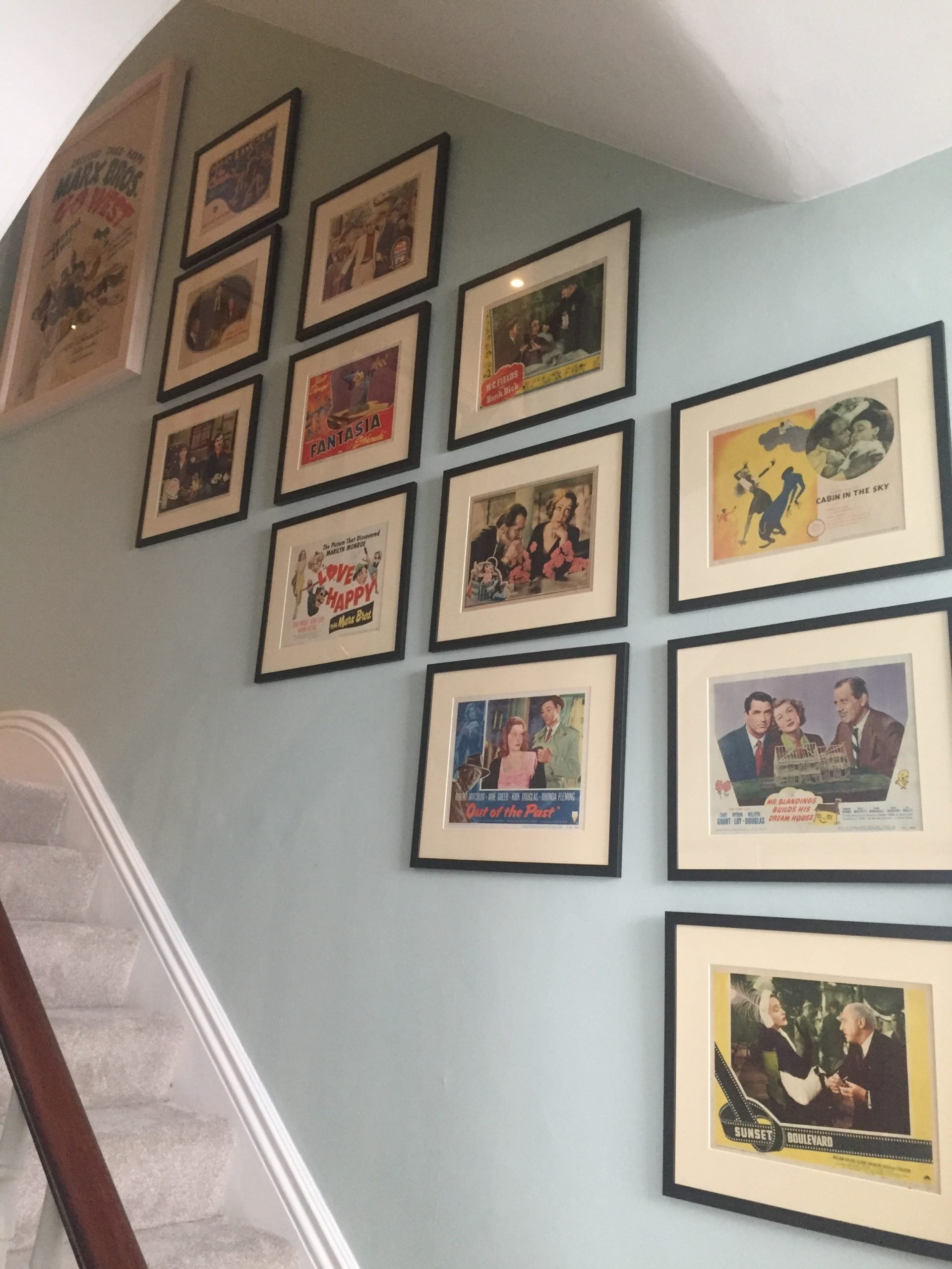 Vintage original lobby cards decorating a stairway