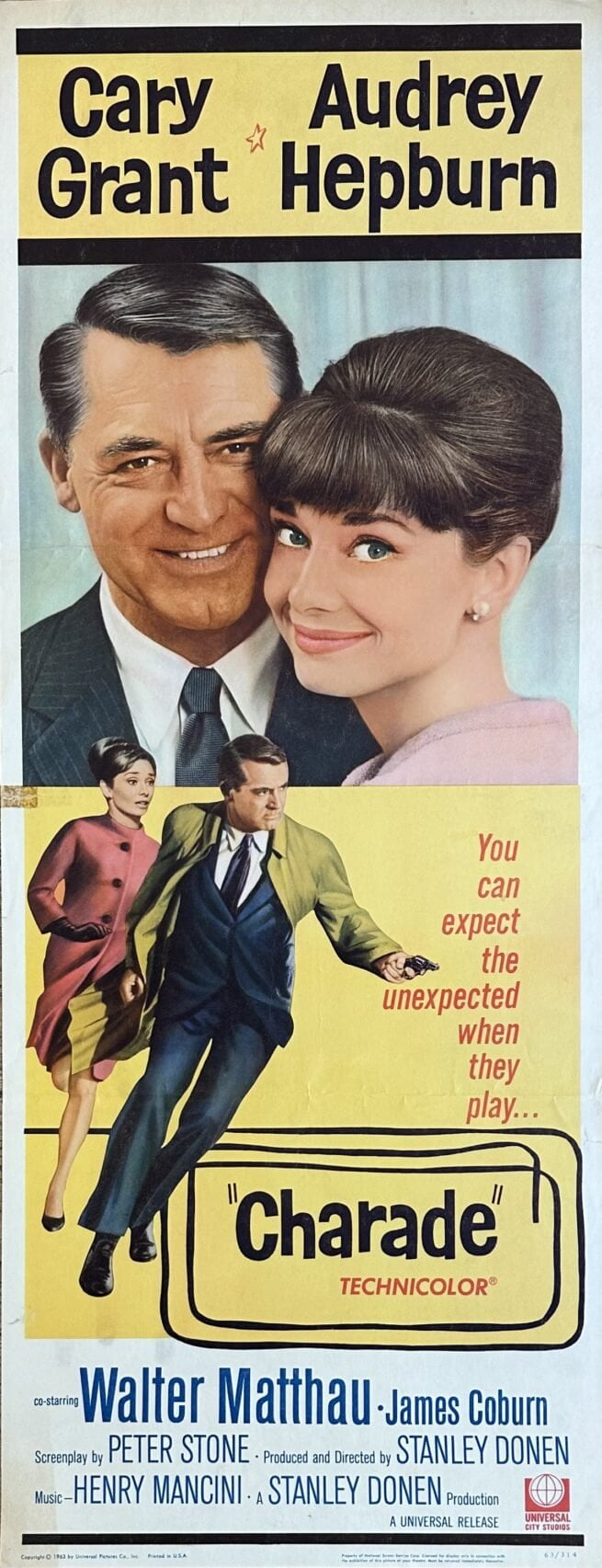 Original vintage cinema movie poster for the thriller, Charade, starring Cary Grant and Audrey Hepburn